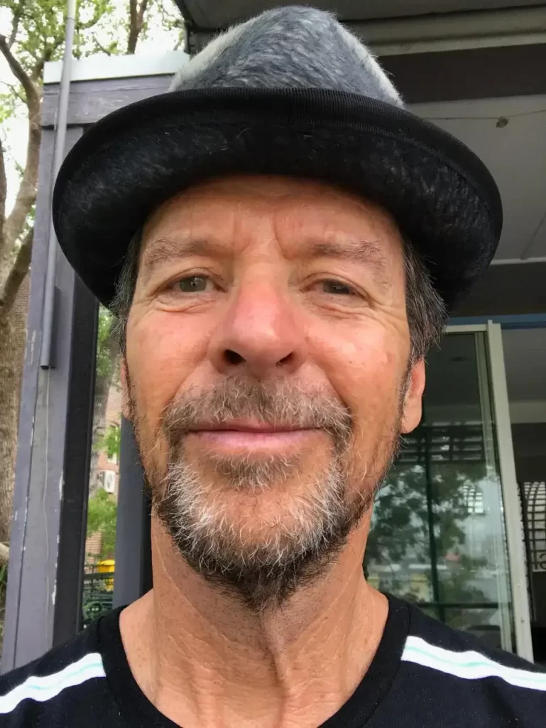 A selfie of a man wearing a hat