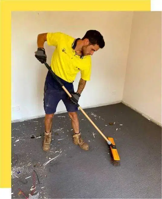 Goodbye junk employee wearing a uniform and cleaning a carpet with brush with a yellow image border